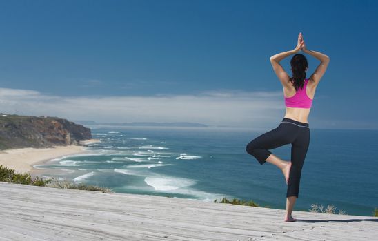 Beautiful young woman in outdoor doing yoga