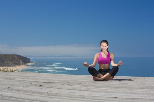 Beautiful young woman in outdoor doing yoga
