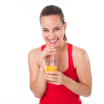 Portrait of a woman drinking an orange juice with a straw and laughing, isolated on white