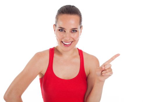 Smiling young woman showing something with her finger, copyspace, isolated on white 