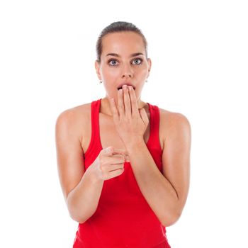 Young smiling woman showing something in front of her and looking very surprised, copyspace, isolated on white 