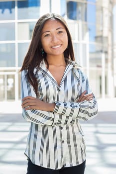 Portrait of a pretty asian businesswoman standing and looking the camera