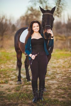 Young woman with a horse on nature