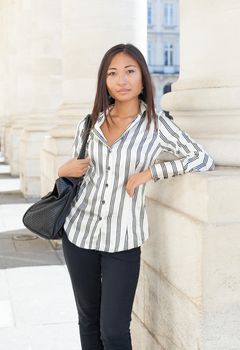 Portrait of a young asian girl standing and looking the camera
