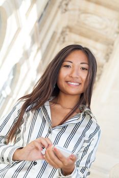 Beautiful asian girl smiling and using smart phone