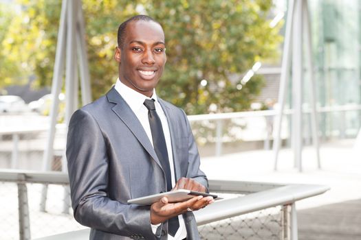 Portrait of a businessman working on electronic tablet