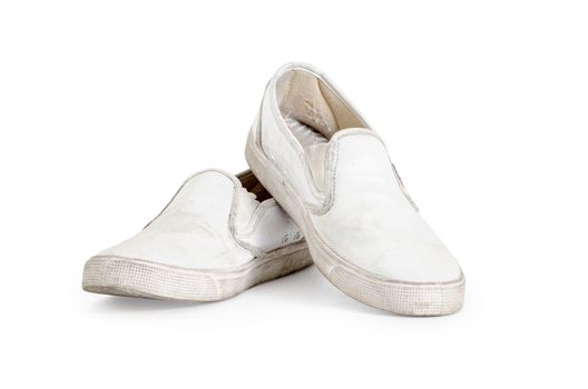 A pair of old dirty sneakers on a white background, isolated