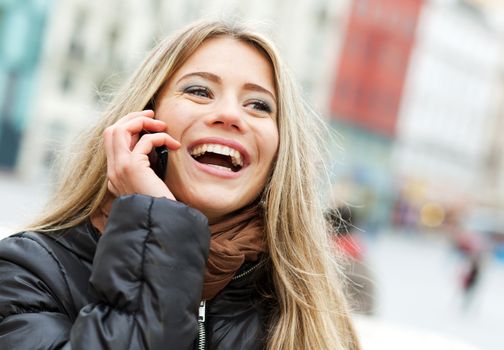 Pretty woman laughing on the phone