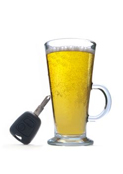Car key resting on a glass of beer 