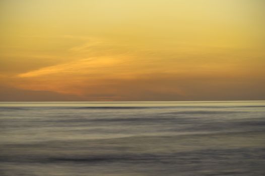 Long exposure of a blazing orange sunset as seen over the Pacific off Costa Rica.