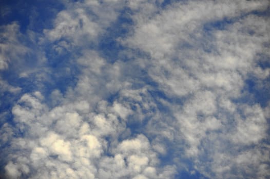  White sparse clouds over blue sky 