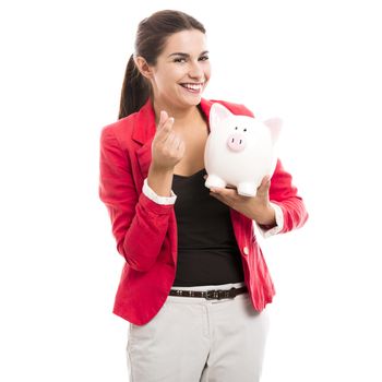 Business woman holding a piggy bank on the hands, isolated over a white background