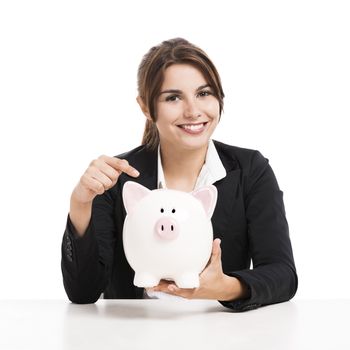 Beautiful hispanic business woman holding a piggy bank, isolated over white background