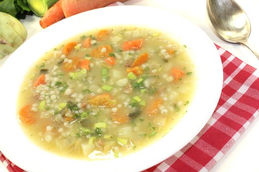 fresh Barley porridge with carrots on a light background