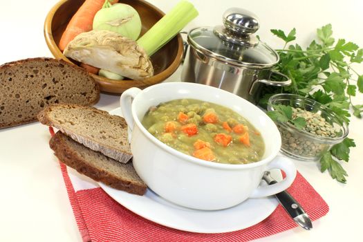a white cup with pea soup and parsley