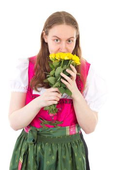 Beautiful girl in dirndl with bunch of yellow roses