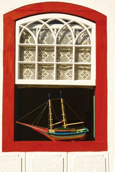 boat model at a window of the beautiful portuguese colonial typical town of parati in rio de janeiro state brazil