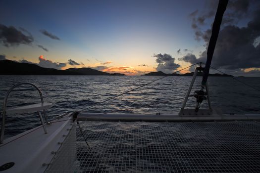 view from a sailling boat of a sunset on saint anne 's bay inpraslin seychelles islands indian ocean