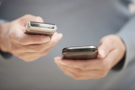Human hands using two smartphones for data transfer