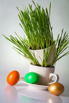 Easter eggs with fresh green grass. Holiday composition