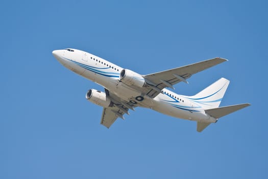 Beautiful white passenger airplane in blue sky