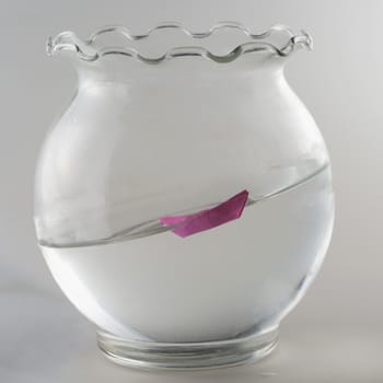 Little pink paper ship sailing uphill in small vase