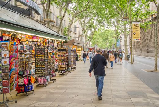 BARCELONA, SPAIN - MAY 31 People walking in the famous and touristic La Rambla street, in Barcelona, Spain, on May 31, 2013