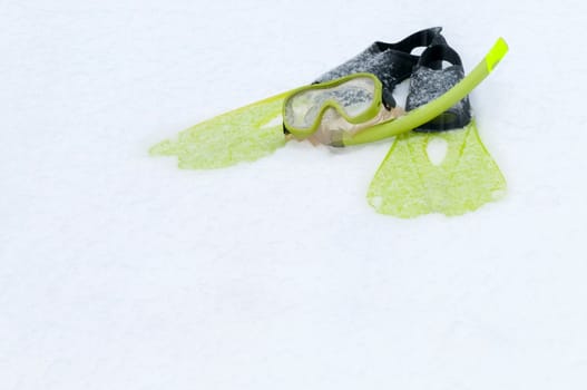 Shot of snorkel, mask and flippers lying on the snow