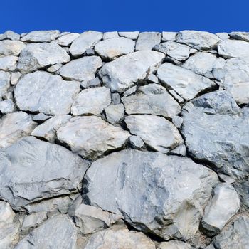 Stone wall background and texture with blue sky 