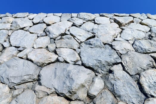 Stone wall background and texture with blue sky 