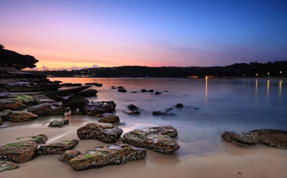 Dawn capture from the southern side of Rocky Point Island.   The tide washing in and out over the shoreline rocks.  Buyers - Motion, long exposure.