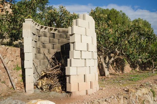 Simple concrete structure to safely burn pruning waste