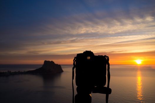 Camera on tripod to shoot a scenic Mediterranean sunrise