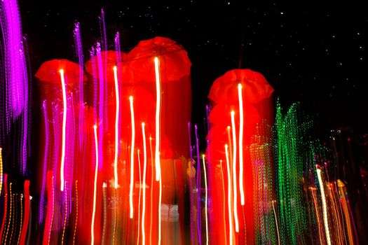 speed of umbrellas neon light in the night sky