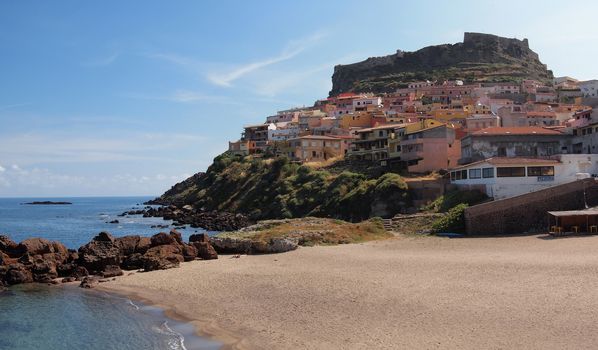 The sardinian coastal town Castelsardo, built upon a cliff on the north coast of Sardinia, Italy with a beach and a fortress.