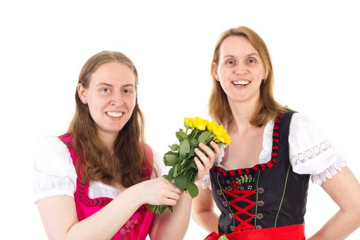 Beautiful and happy women in dirndl with bunch of roses
