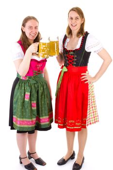 Beautiful women in dirndl drinking double beer at bavarian feast