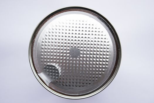 Silver colored can with sealed top on a white background.