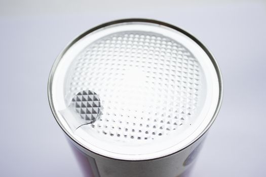 Silver colored can with sealed top on a white background.