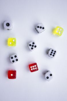 Composition from different colored dice on a white background.