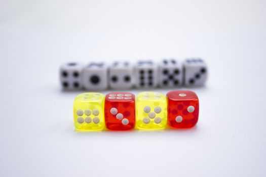 Composition from different colored dice on a white background.