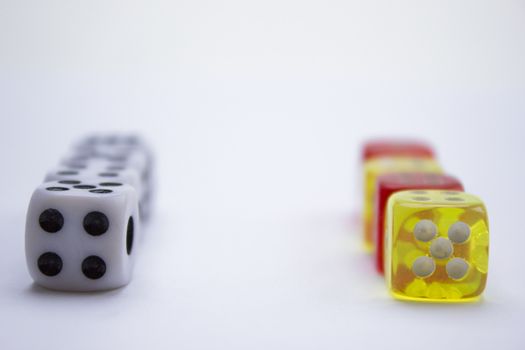 Composition from different colored dice on a white background.