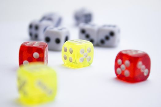 Composition from different colored dice on a white background.