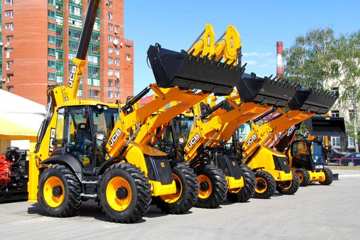 UFA, RUSSIA - MAY 22: Line of JCB machinery at the annual International exhibition "Gas. Oil. Technologies" on May 22, 2012 in Ufa, Bashkortostan, Russia.