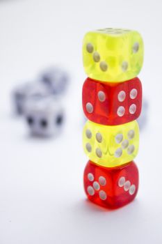 Composition from different colored dice on a white background.