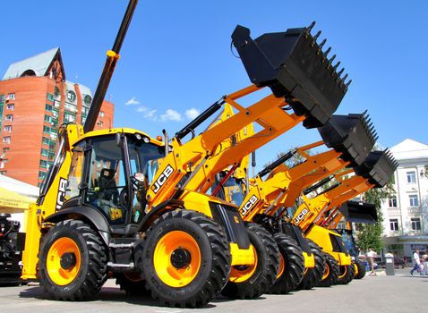 UFA, RUSSIA - MAY 22: Line of JCB machinery at the annual International exhibition "Gas. Oil. Technologies" on May 22, 2012 in Ufa, Bashkortostan, Russia.