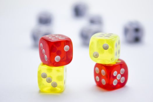 Composition from different colored dice on a white background.