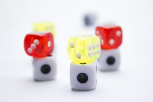 Composition from different colored dice on a white background.