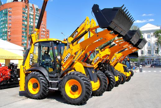 UFA, RUSSIA - MAY 22: Line of JCB machinery at the annual International exhibition "Gas. Oil. Technologies" on May 22, 2012 in Ufa, Bashkortostan, Russia.