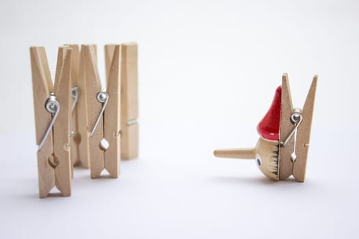 Composition of several wooden pegs on a white background.